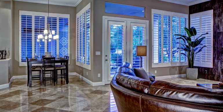 Minneapolis great room with classic shutters and tile floor.